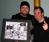 Me holding up the purchased artwork with artist Brian